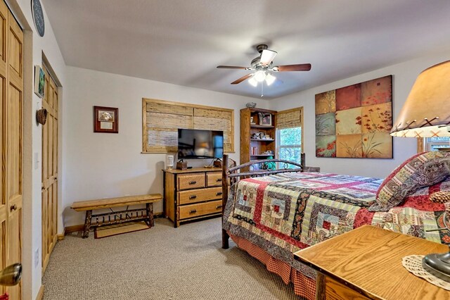 bedroom featuring ceiling fan, baseboards, and carpet