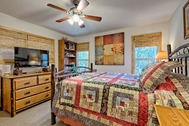 bedroom featuring light colored carpet and ceiling fan