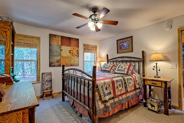 bedroom with multiple windows, baseboards, and carpet floors