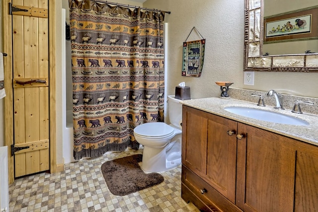 full bath with shower / bath combo, toilet, vanity, and a textured wall