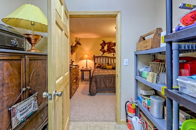 bedroom with carpet floors and tile patterned flooring