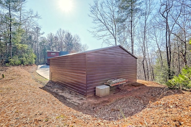 view of property exterior with an outbuilding