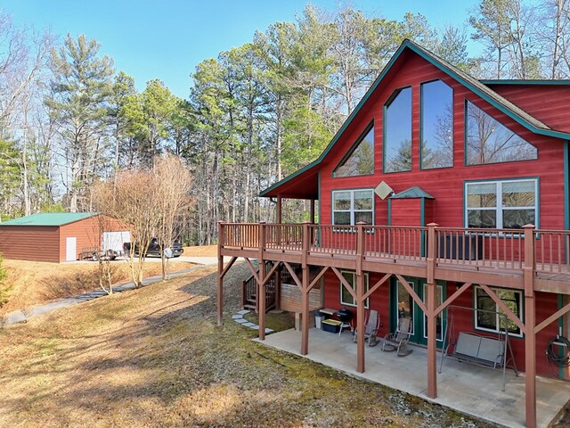 rear view of property with a patio area and a wooden deck