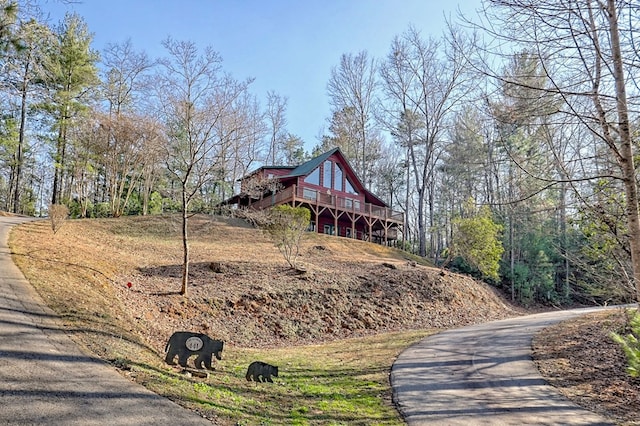 exterior space featuring driveway and a wooden deck