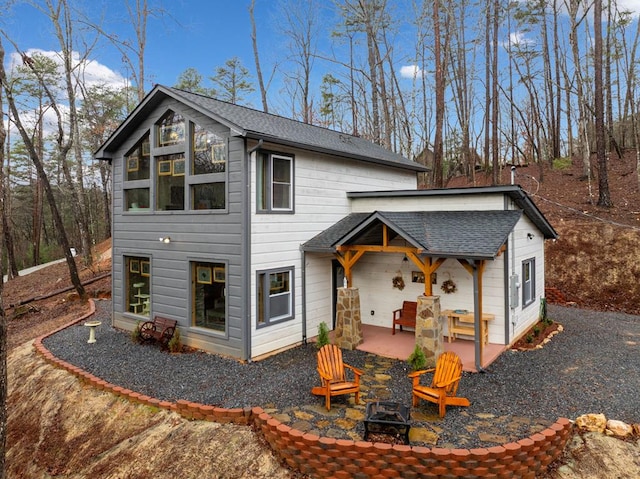 view of front facade featuring an outdoor fire pit and a patio