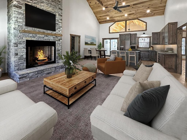 living room featuring ceiling fan, a stone fireplace, high vaulted ceiling, and wooden ceiling