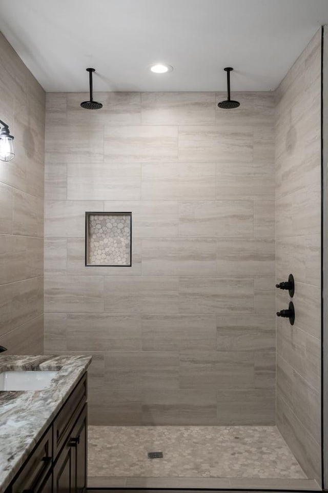 bathroom featuring vanity and a tile shower