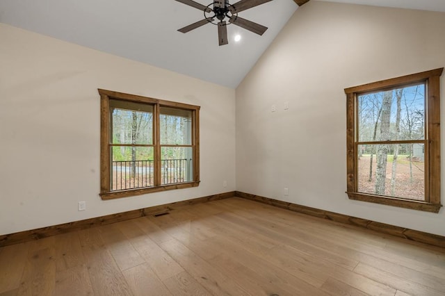 unfurnished room featuring ceiling fan, high vaulted ceiling, and light wood-type flooring