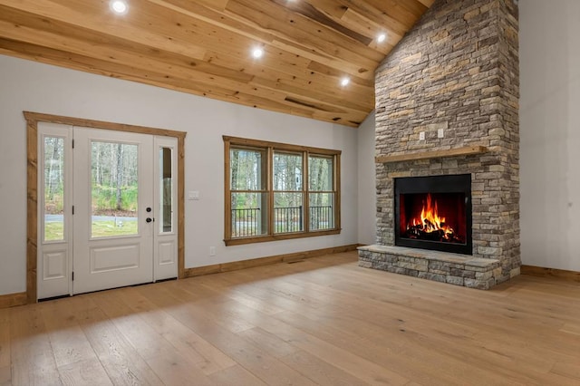 doorway featuring wood ceiling, a fireplace, plenty of natural light, and light wood-type flooring