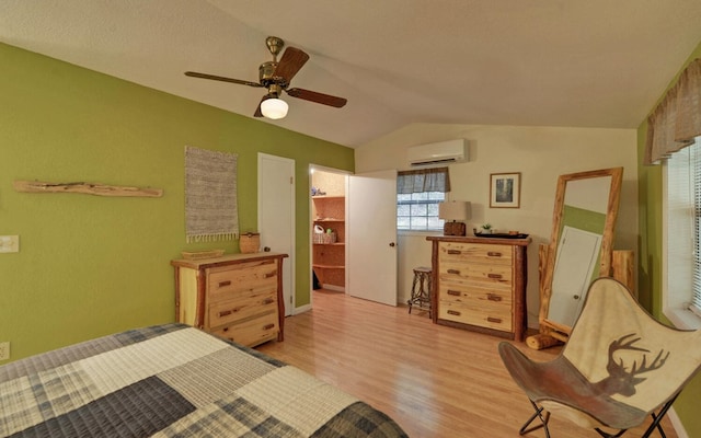 5557 Joe Brown Hwy, Murphy, NC 28906 - bedroom featuring a wall unit AC, light wood-type flooring, lofted ceiling, and ceiling fan