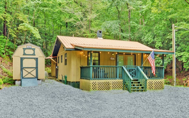 5557 Joe Brown Hwy, Murphy, NC 28906 - view of front of house with a porch, french doors, metal roof, and a forest view