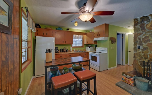5557 Joe Brown Hwy, Murphy, NC 28906 - kitchen with white appliances, under cabinet range hood, baseboards, a ceiling fan, and a textured ceiling