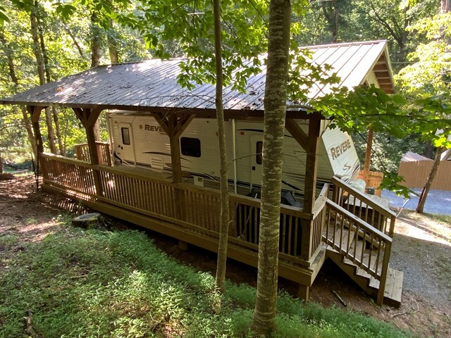 back of property featuring a wooden deck