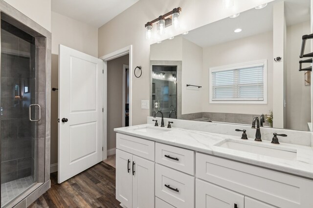 774 Hickory Ridge Dr, Ellijay, GA 30540 - full bathroom with double vanity, a stall shower, a sink, and wood finished floors