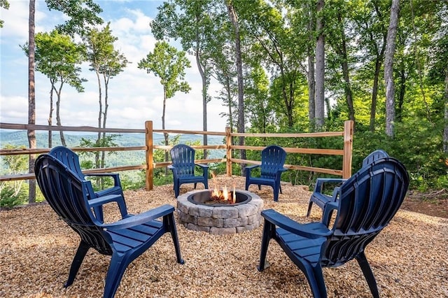 exterior space featuring an outdoor fire pit and a water view