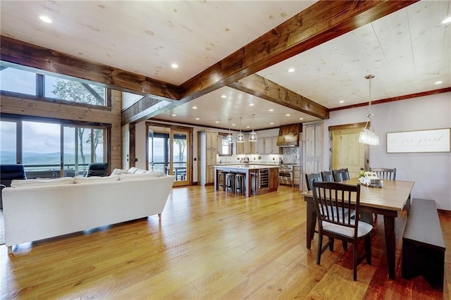 dining area with light wood finished floors, beamed ceiling, and recessed lighting