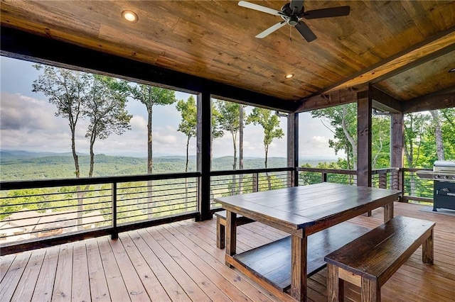 unfurnished sunroom with vaulted ceiling, wooden ceiling, and a wealth of natural light