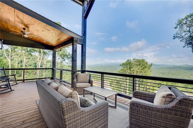 deck with an outdoor hangout area and a ceiling fan