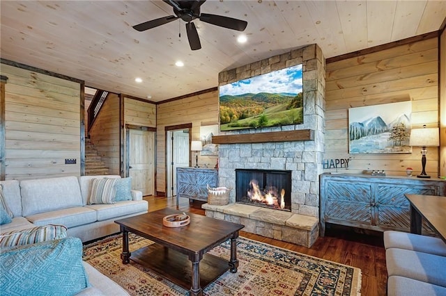 living room featuring wooden ceiling, a stone fireplace, wooden walls, and wood finished floors