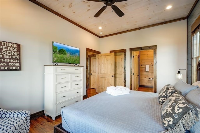 bedroom featuring dark wood-style floors, crown molding, recessed lighting, ensuite bathroom, and baseboards