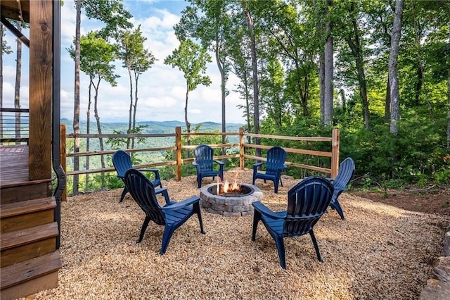 exterior space with a deck with mountain view and a fire pit