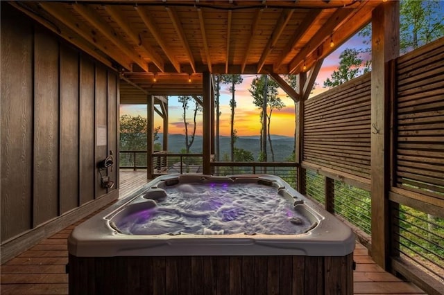 wooden deck with a hot tub