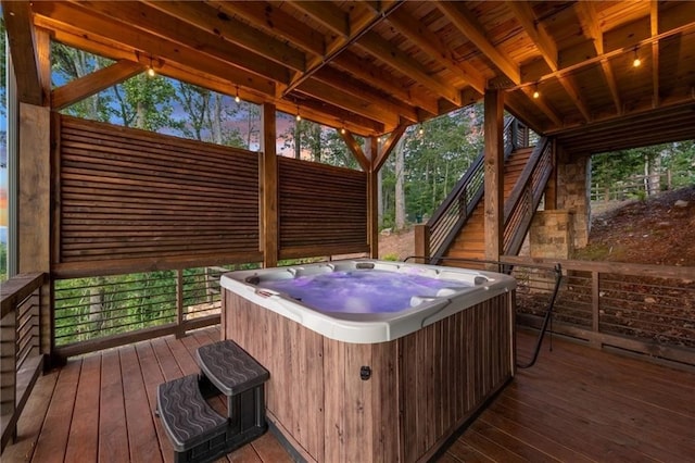 wooden terrace with a hot tub and stairs