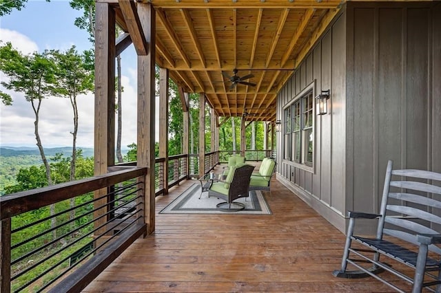 wooden deck featuring a ceiling fan