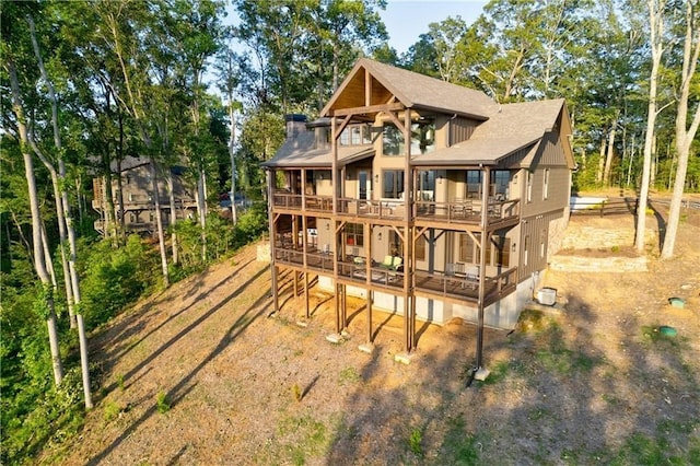 rear view of property with a deck and a balcony