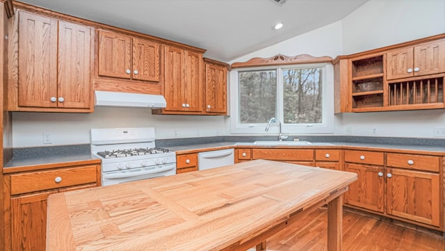 kitchen with white appliances, lofted ceiling, dark wood-type flooring, extractor fan, and a sink