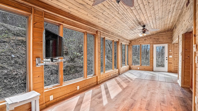 unfurnished sunroom featuring lofted ceiling, wood ceiling, and ceiling fan