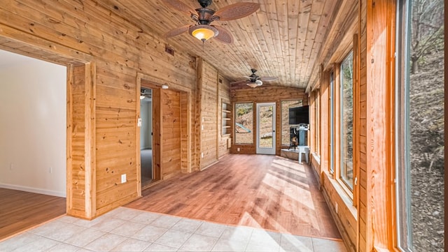 unfurnished sunroom featuring a ceiling fan, lofted ceiling, and wooden ceiling