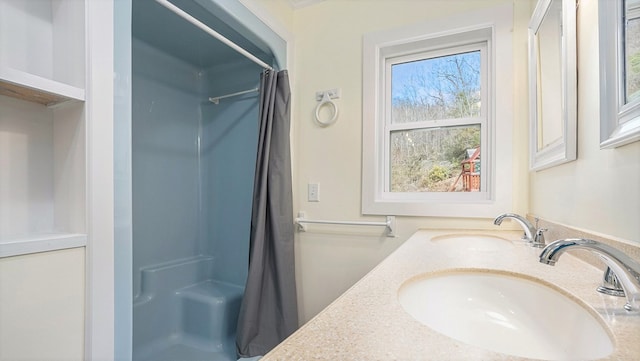 full bath with vanity and a shower with shower curtain