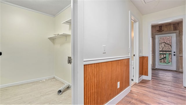 laundry area with wood walls, laundry area, and wood finished floors