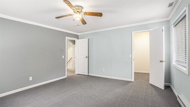 unfurnished bedroom with a textured ceiling, carpet floors, and ornamental molding