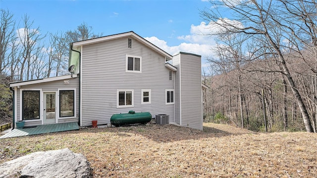 back of property with a deck, central AC unit, and heating fuel