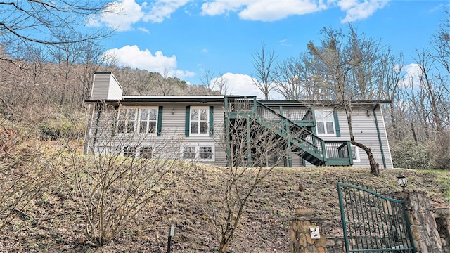 view of home's exterior featuring stairs and a chimney