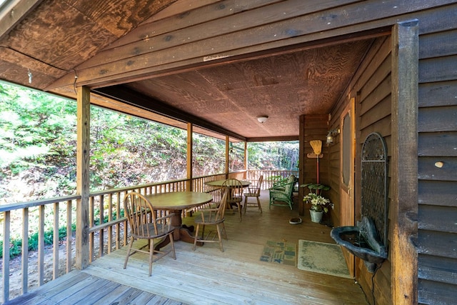 unfurnished sunroom with vaulted ceiling and wood ceiling