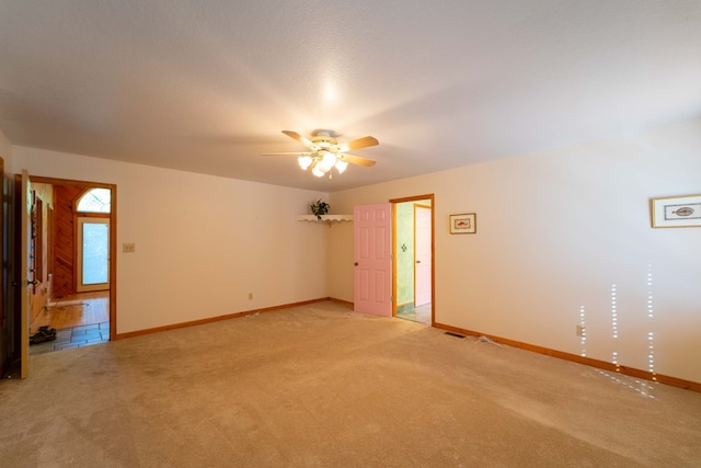 unfurnished room featuring ceiling fan and light colored carpet