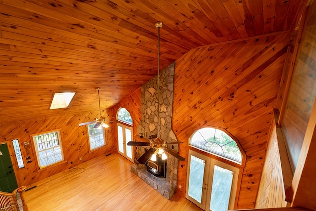 unfurnished living room with a skylight, french doors, high vaulted ceiling, and wooden ceiling