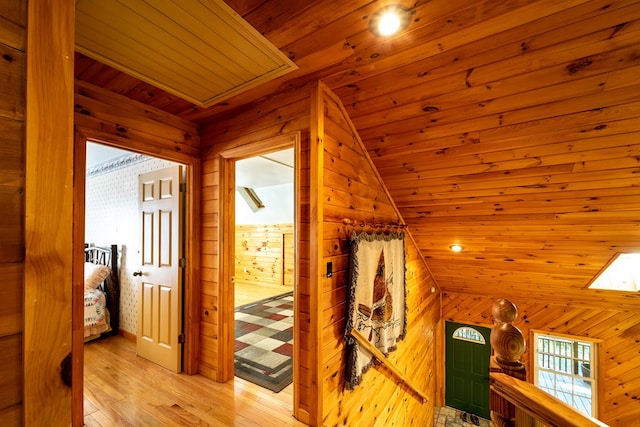 interior space featuring wood walls, wooden ceiling, and vaulted ceiling