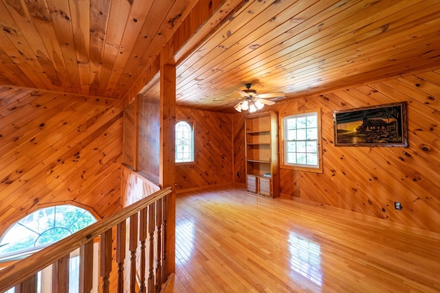 additional living space with ceiling fan, a healthy amount of sunlight, and wood ceiling