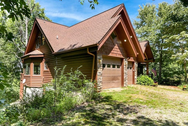 view of side of home with a lawn and a garage