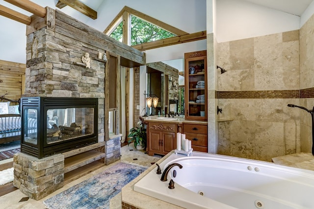 bathroom featuring a stone fireplace, beam ceiling, separate shower and tub, vanity, and high vaulted ceiling