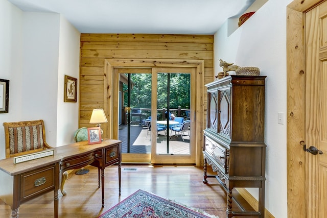 entryway featuring wooden walls and light wood-type flooring