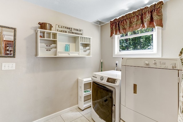 washroom featuring washer and dryer and light tile patterned flooring