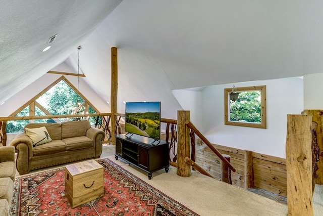 carpeted living room featuring vaulted ceiling