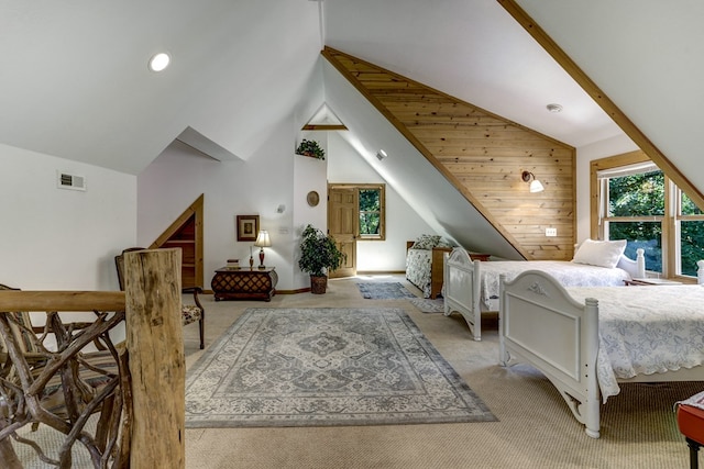 carpeted bedroom with wooden walls and vaulted ceiling