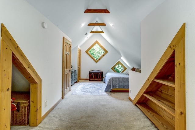 carpeted bedroom featuring lofted ceiling with skylight