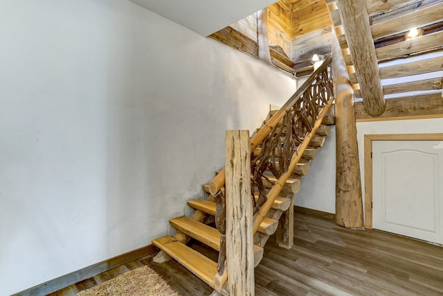 stairway with hardwood / wood-style floors